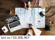 Map lying on wooden table. Стоковое фото, агентство Ingram Publishing / Фотобанк Лори