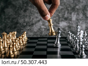 Hand of man playing chess for business planning and comparison of metaphor, selective focus. Стоковое фото, агентство Ingram Publishing / Фотобанк Лори