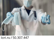 Doctor with antiseptic. Coronavirus theme. Стоковое фото, агентство Ingram Publishing / Фотобанк Лори