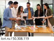 Interracial asian business team brainstorming idea talk and discuss at office meeting room after reopen due to coronavirus COVID-19 city lockdown. Business startup meeting and brainstorm concept. Стоковое фото, агентство Ingram Publishing / Фотобанк Лори