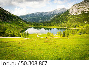 A beautiful scenery of a green valley near the Alp mountains in Austria under the cloudy sky. Beautiful scenery of a green valley near the Alp mountains in Austria under the cloudy sky. Стоковое фото, агентство Ingram Publishing / Фотобанк Лори