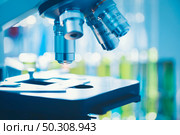 Close-up shot of microscope with metal lens at laboratory, Modern medical laboratory equipment. Стоковое фото, агентство Ingram Publishing / Фотобанк Лори