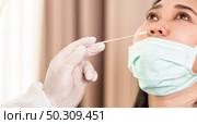 Panorama close up Medical staff with PPE suit test coronavirus covid-19 to asian woman by nose swab at hosputal. COVID-19 testing health care concept. Стоковое фото, агентство Ingram Publishing / Фотобанк Лори
