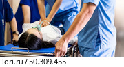Panoramic Close up Medical team do CPR to seriously injured patient with oxygen mask while push gurney stretcher bed to Operating Room. Emergency health care and medical hospital concept. Стоковое фото, агентство Ingram Publishing / Фотобанк Лори