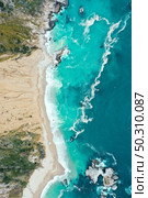 A vertical overhead shot of the beautiful shoreline of the sea with blue clean water and sandy beach. Vertical overhead shot of the beautiful shoreline of the sea with blue clean water and sandy beach. Стоковое фото, агентство Ingram Publishing / Фотобанк Лори