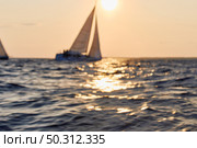 Sailing regatta in the Gulf of Finland at sunset, sailing yacht competing in a race, splashing water from under the boat, teamwork, board the boat. Стоковое фото, фотограф Vladimir Drozdin / Фотобанк Лори