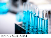 test-tube and laboratory glassware setting for science research, medical study, experiments for researching modern medical innovations, blue liquid sample test. Стоковое фото, агентство Ingram Publishing / Фотобанк Лори