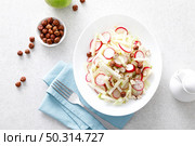 Fresh fruit and vegetable salad with kohlrabi, green apple, radish and hazelnuts. Стоковое фото, агентство Ingram Publishing / Фотобанк Лори