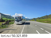 Regular white bus from Barnaul in a remote Altai village. Редакционное фото, фотограф Саблин Станислав / Фотобанк Лори
