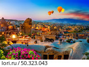 Goreme town on sunset in Cappadocia, Central Anatolia,Turkey. Balloons at sunrise in Turkey. Стоковое фото, агентство Ingram Publishing / Фотобанк Лори