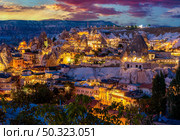Goreme town on sunset in Cappadocia, Central Anatolia,Turkey. lights of the town of Goreme. Стоковое фото, агентство Ingram Publishing / Фотобанк Лори