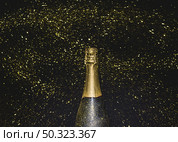 bottle champagne flying golden glitters. Стоковое фото, агентство Ingram Publishing / Фотобанк Лори