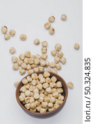 hazelnuts spilled near bowl. Стоковое фото, агентство Ingram Publishing / Фотобанк Лори