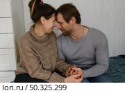 Mature couple hugging hugging each other kissing at home bedroom. Intimate Moment. Tender embrace shared between a loving middle age man and woman, husband and wife. Deep love. Low key, cinematic. Стоковое фото, фотограф Марина Демидюк / Фотобанк Лори