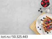 top view delicious sweet waffles. Resolution and high quality beautiful photo. top view delicious sweet waffles. High quality and resolution beautiful photo concept. Стоковое фото, агентство Ingram Publishing / Фотобанк Лори