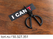 top view i cant message card being cut with scissor. High resolution photo. top view i cant message card being cut with scissor. High quality photo. Стоковое фото, агентство Ingram Publishing / Фотобанк Лори