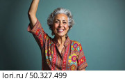 A woman with gray hair, dressed in vibrant, patterned clothing, standing confidently with her arm raised, soft lighting studio background. Стоковое AI-видео, аниматор Sergey Grishin / Фотобанк Лори