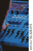 Close-up of a mixing console with various sliders and buttons. The sound engineer's hand adjusts the level and controls the recording process. Стоковое видео, видеограф Воловодов Владимир / Фотобанк Лори