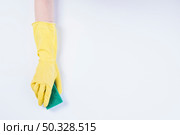 janitor s hand with yellow gloves holding sponge white background. High resolution photo. janitor s hand with yellow gloves holding sponge white background. High quality photo. Стоковое фото, агентство Ingram Publishing / Фотобанк Лори