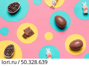 overhead view easter eggs rabbit choco chips round frame pink background. High resolution photo. overhead view easter eggs rabbit choco chips round frame pink background. High quality photo. Стоковое фото, агентство Ingram Publishing / Фотобанк Лори