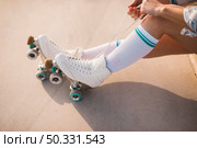 low section woman tying roller skate lace. High resolution photo. low section woman tying roller skate lace. High quality photo. Стоковое фото, агентство Ingram Publishing / Фотобанк Лори