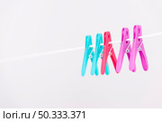 colourful clothes pins hanging clothesline. Стоковое фото, агентство Ingram Publishing / Фотобанк Лори