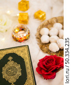 OLYMPUS DIGITAL CAMERA. top view table arrangement with quran roses pastries. Стоковое фото, агентство Ingram Publishing / Фотобанк Лори
