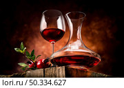 Pomegranate wine on a wooden table in a glass bowl. Pomegranate wine in a decanter. Стоковое фото, агентство Ingram Publishing / Фотобанк Лори