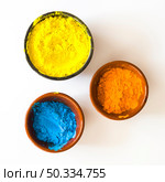 bowls yellow orange blue color powder isolated white background. Стоковое фото, агентство Ingram Publishing / Фотобанк Лори