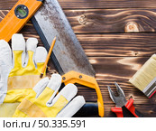 OLYMPUS DIGITAL CAMERA. various implements carpenter wooden desk. Стоковое фото, агентство Ingram Publishing / Фотобанк Лори
