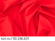 folded red textile fabric texture background. Стоковое фото, агентство Ingram Publishing / Фотобанк Лори