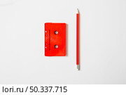 red cassette tape pencil white background. Стоковое фото, агентство Ingram Publishing / Фотобанк Лори