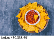 top view mexican nachos chips with spicy salsa sauce container. Стоковое фото, агентство Ingram Publishing / Фотобанк Лори
