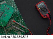 close up circuit board with multimeter. Стоковое фото, агентство Ingram Publishing / Фотобанк Лори
