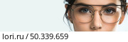 A detailed view of a persons face wearing eyeglasses, showcasing the frames and lenses clearly. Стоковое AI-изображение, AI-художник Данила Большаков / Фотобанк Лори