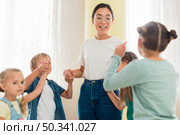 children playing with their kindergarten teacher. Стоковое фото, агентство Ingram Publishing / Фотобанк Лори
