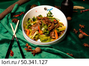 Stir Fried Beef and Celery With Red Peppers in a Bowl on Green Velvet. Стоковое фото, фотограф Aleksandr Golubev / Фотобанк Лори