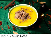 Yellow Soup Topped With Sliced Beef Garnished With Star Anise On Dark Green Fabric. Стоковое фото, фотограф Aleksandr Golubev / Фотобанк Лори