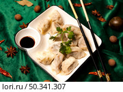 Steaming Chinese Dumplings With Soy Sauce Presented Beautifully on a Table. Стоковое фото, фотограф Aleksandr Golubev / Фотобанк Лори