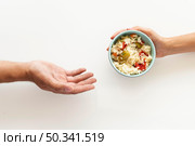 hand giving food bowl needy person. Стоковое фото, агентство Ingram Publishing / Фотобанк Лори