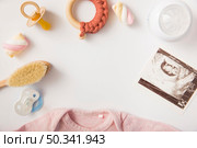 pacifier marshmallow brush toy milk bottle sonography picture baby onesie white background. Стоковое фото, агентство Ingram Publishing / Фотобанк Лори
