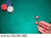 poker player s hand throwing red dices poker table. Стоковое фото, агентство Ingram Publishing / Фотобанк Лори