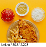 top view fish chips plate with sauces. Стоковое фото, агентство Ingram Publishing / Фотобанк Лори