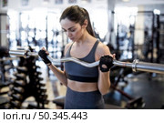 woman with barbell gym. Стоковое фото, агентство Ingram Publishing / Фотобанк Лори