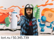 man s hand holding white aerosol can. Стоковое фото, агентство Ingram Publishing / Фотобанк Лори