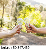 concept clinking bulbs hands nature. Стоковое фото, агентство Ingram Publishing / Фотобанк Лори