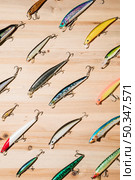 diagonal colorful fishing lures wooden surface. Стоковое фото, агентство Ingram Publishing / Фотобанк Лори