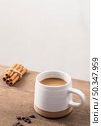 high angle coffee mug with cinnamon sticks copy space. Стоковое фото, агентство Ingram Publishing / Фотобанк Лори