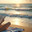 Женщина читает книгу на пляже на закате / A woman reads a book on the beach at sunset. Стоковое AI-изображение, AI-художник Валерий Лукин / Фотобанк Лори