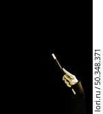 magician s hand holding magic wand against black background. Стоковое фото, агентство Ingram Publishing / Фотобанк Лори